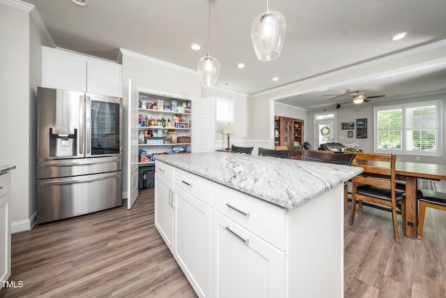 1705 Main Divide Dr, Wake Forest, NC 27587 - kitchen featuring stainless steel fridge with ice dispenser, ornamental molding, white cabinets, recessed lighting, and light stone counters