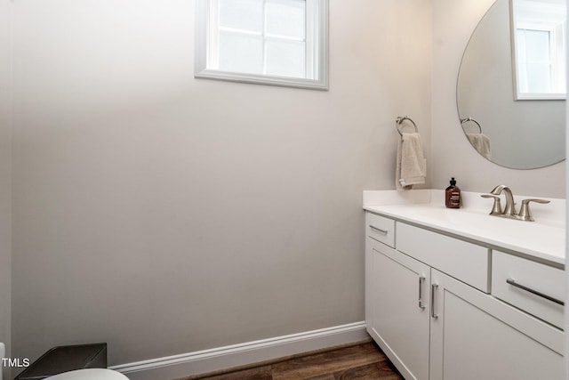 1705 Main Divide Dr, Wake Forest, NC 27587 - half bathroom with vanity, toilet, baseboards, and wood finished floors