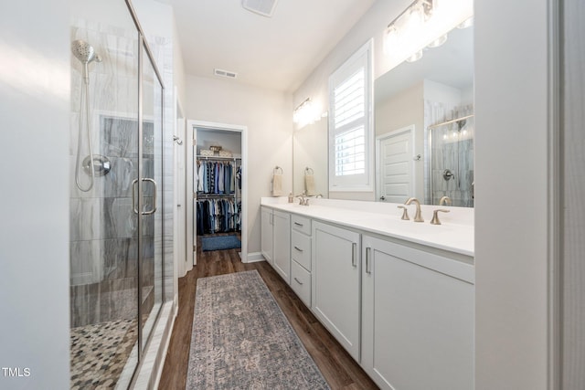 1705 Main Divide Dr, Wake Forest, NC 27587 - full bathroom with a shower stall, wood finished floors, double vanity, and a spacious closet