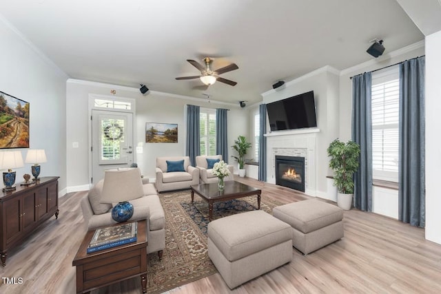 1705 Main Divide Dr, Wake Forest, NC 27587 - living area with a glass covered fireplace, crown molding, a ceiling fan, light wood-style flooring, and baseboards
