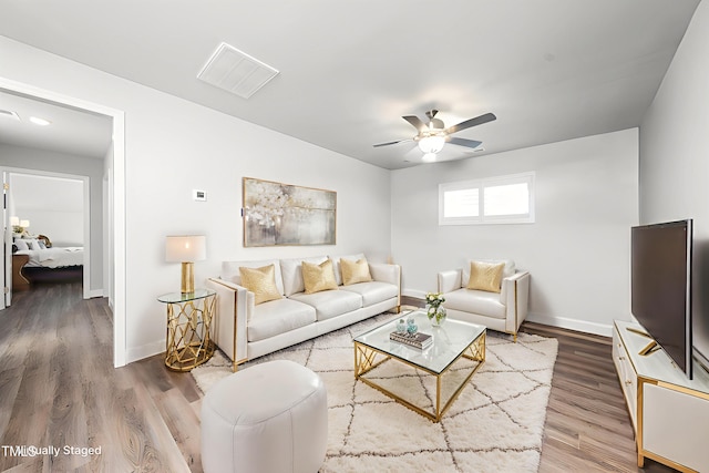 1705 Main Divide Dr, Wake Forest, NC 27587 - living room with a ceiling fan, wood finished floors, and baseboards