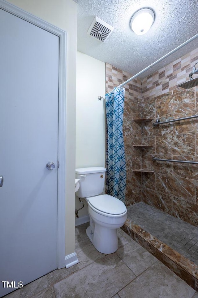 6767 Cedar Chest Ct, Fayetteville, NC 28314 - full bath with a tile shower, toilet, and a textured ceiling