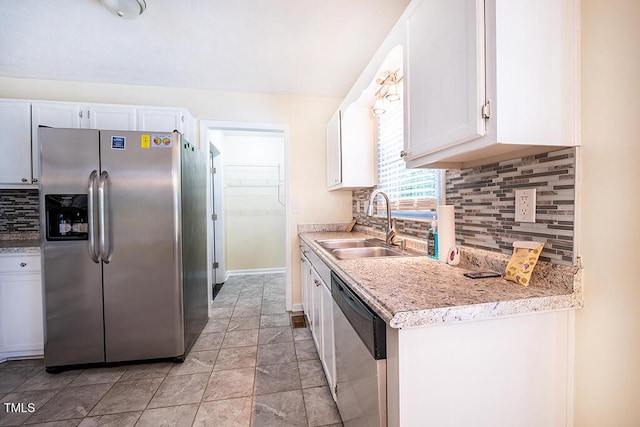 6767 Cedar Chest Ct, Fayetteville, NC 28314 - kitchen with appliances with stainless steel finishes, a sink, white cabinetry, and decorative backsplash