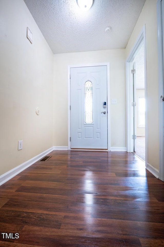 6767 Cedar Chest Ct, Fayetteville, NC 28314 - foyer entrance featuring a textured ceiling, wood finished floors, baseboards, and healthy amount of natural light