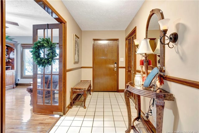 103 Kensington St, Lumberton, NC 28358 - foyer with a textured ceiling, baseboards, and light wood-type flooring