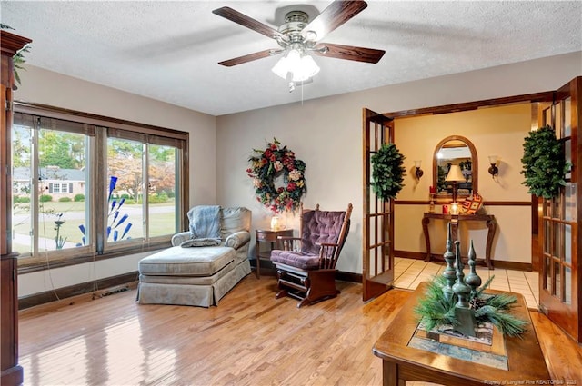 103 Kensington St, Lumberton, NC 28358 - sitting room featuring light wood-style flooring, a ceiling fan, a textured ceiling, and baseboards