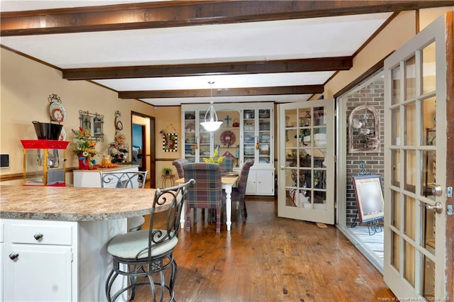 103 Kensington St, Lumberton, NC 28358 - kitchen with french doors, white cabinetry, hardwood / wood-style flooring, beamed ceiling, and light countertops