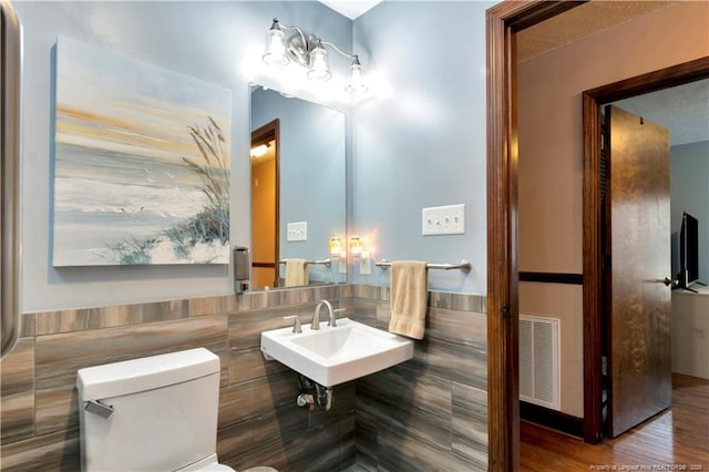 103 Kensington St, Lumberton, NC 28358 - half bathroom featuring toilet, a sink, and wood finished floors