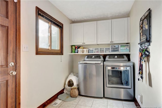103 Kensington St, Lumberton, NC 28358 - washroom featuring cabinet space, washing machine and dryer, light tile patterned flooring, and baseboards