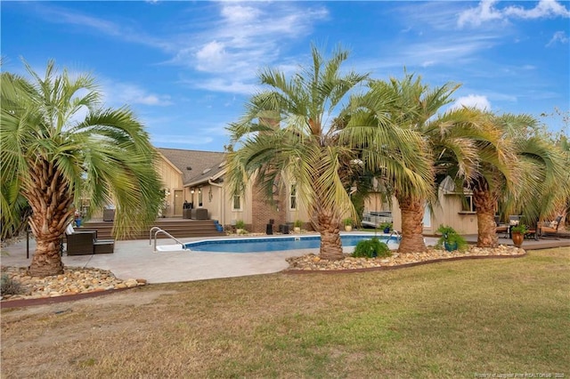 103 Kensington St, Lumberton, NC 28358 - swimming pool featuring a patio and a lawn