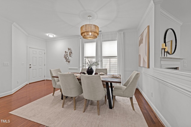 904 Pirouette Ct, Raleigh, NC 27606 - dining room with ornamental molding, wood finished floors, a chandelier, and baseboards