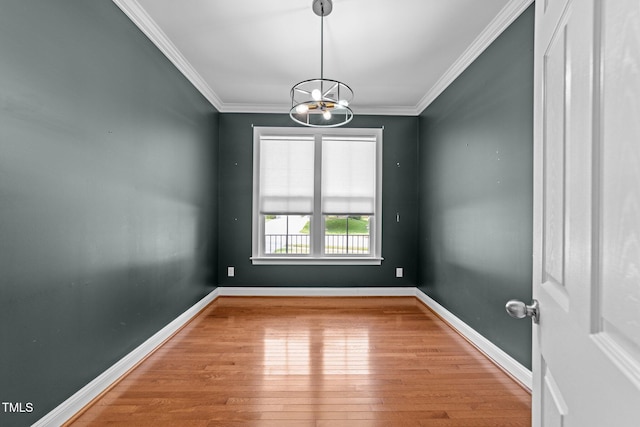 904 Pirouette Ct, Raleigh, NC 27606 - spare room with a chandelier, wood finished floors, crown molding, and baseboards