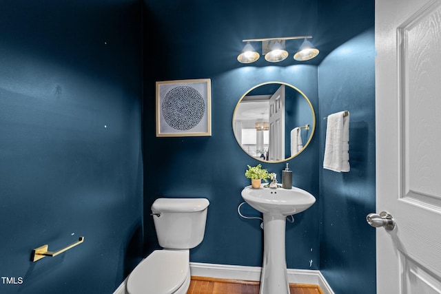 904 Pirouette Ct, Raleigh, NC 27606 - half bath featuring toilet, wood finished floors, and baseboards