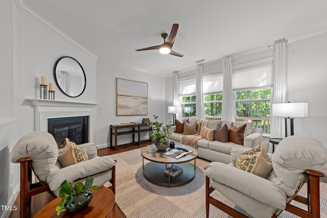 904 Pirouette Ct, Raleigh, NC 27606 - living room with ornamental molding, a ceiling fan, a glass covered fireplace, wood finished floors, and baseboards