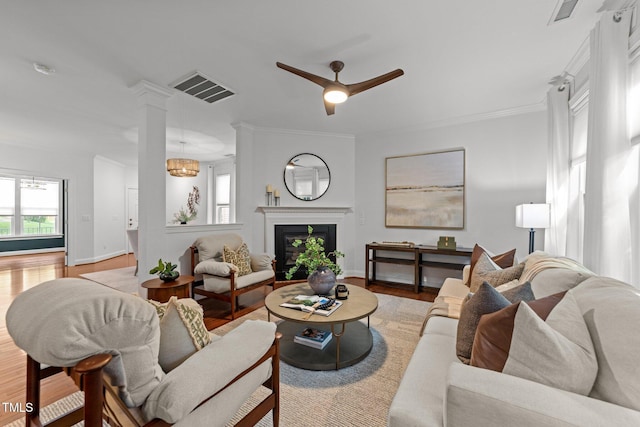 904 Pirouette Ct, Raleigh, NC 27606 - living area with light wood finished floors, baseboards, ceiling fan, a fireplace, and crown molding