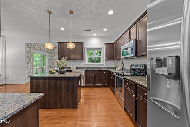 904 Pirouette Ct, Raleigh, NC 27606 - kitchen with stainless steel appliances, plenty of natural light, dark brown cabinets, a center island, and recessed lighting
