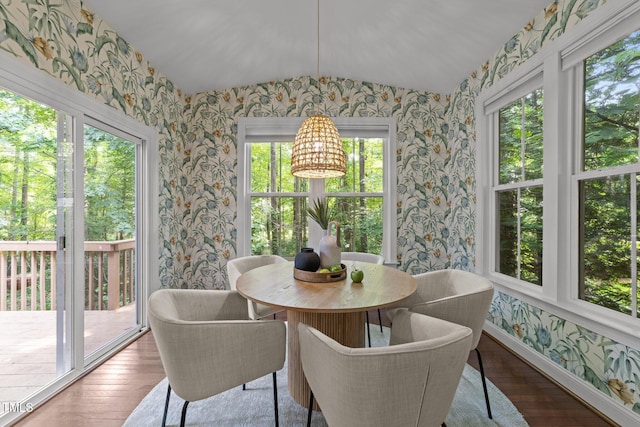 904 Pirouette Ct, Raleigh, NC 27606 - dining room with wallpapered walls, vaulted ceiling, wood finished floors, and baseboards