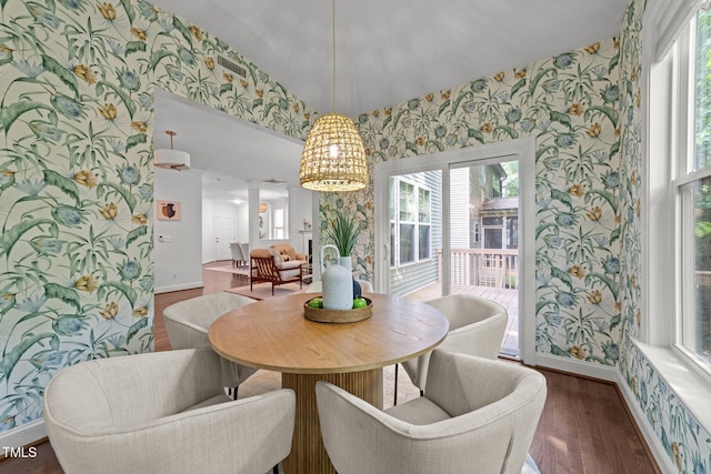 904 Pirouette Ct, Raleigh, NC 27606 - dining area featuring wallpapered walls, wood finished floors, baseboards, ornate columns, and plenty of natural light