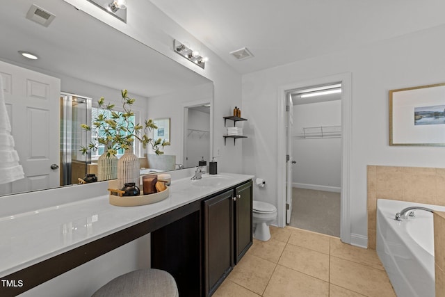 904 Pirouette Ct, Raleigh, NC 27606 - bathroom with toilet, a spacious closet, a bath, vanity, and tile patterned floors