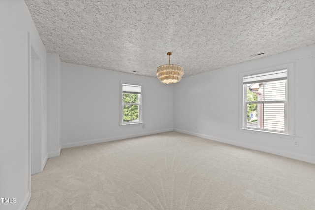 904 Pirouette Ct, Raleigh, NC 27606 - spare room with light carpet, a chandelier, and baseboards