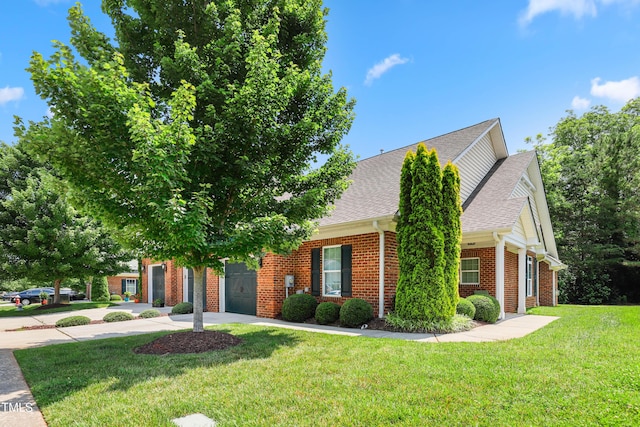 127 Bobwhite Way, Mebane, NC 27302 - obstructed view of property with a garage, brick siding, a shingled roof, concrete driveway, and a front yard