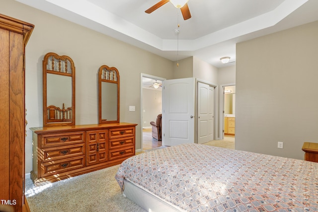 127 Bobwhite Way, Mebane, NC 27302 - bedroom with carpet floors, a tray ceiling, ceiling fan, and ensuite bath