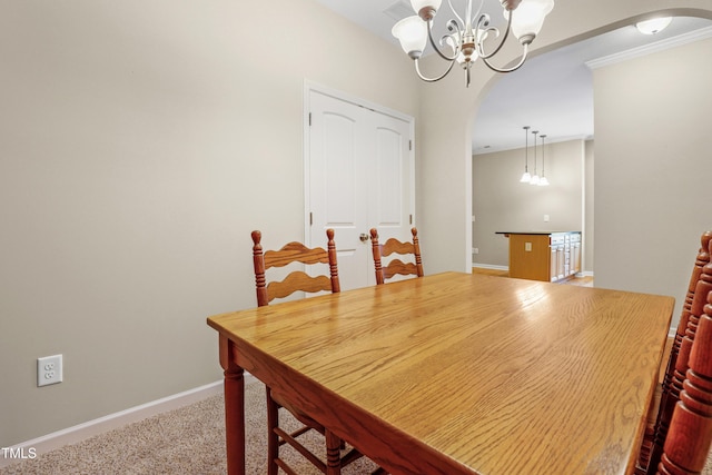 127 Bobwhite Way, Mebane, NC 27302 - dining space with arched walkways, a chandelier, baseboards, carpet floors, and crown molding