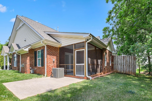 127 Bobwhite Way, Mebane, NC 27302 - back of house with brick siding, central air condition unit, a sunroom, a patio area, and a shingled roof