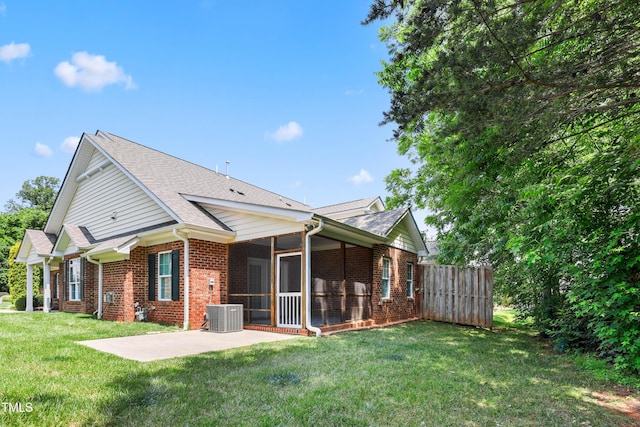 127 Bobwhite Way, Mebane, NC 27302 - back of house with brick siding, a patio area, a sunroom, central AC unit, and roof with shingles