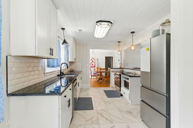 492 N Dunn St, Angier, NC 27501 - kitchen with stainless steel appliances, white cabinetry, light marble finish flooring, decorative backsplash, and pendant lighting