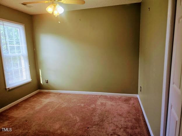 5301 Peacenest Dr, Raleigh, NC 27610 - spare room featuring a ceiling fan, carpet, and baseboards