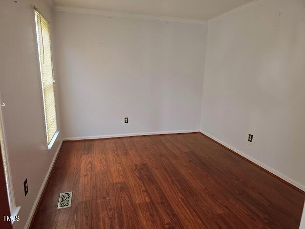 5301 Peacenest Dr, Raleigh, NC 27610 - spare room featuring wood finished floors, baseboards, and crown molding