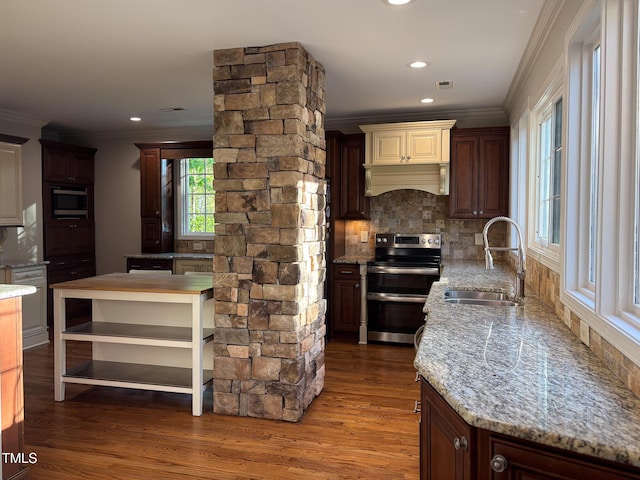119 W Vernon Ave, Wake Forest, NC 27587 - kitchen with appliances with stainless steel finishes, a sink, ornamental molding, wood finished floors, and tasteful backsplash