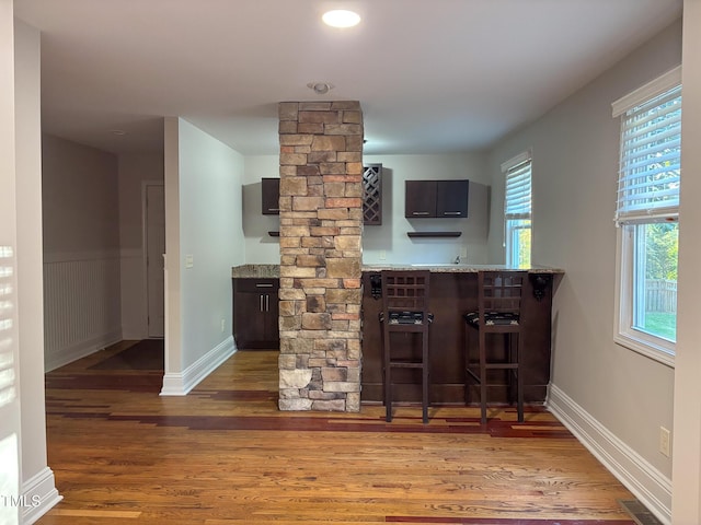 119 W Vernon Ave, Wake Forest, NC 27587 - bar area featuring decorative columns, wood finished floors, and baseboards