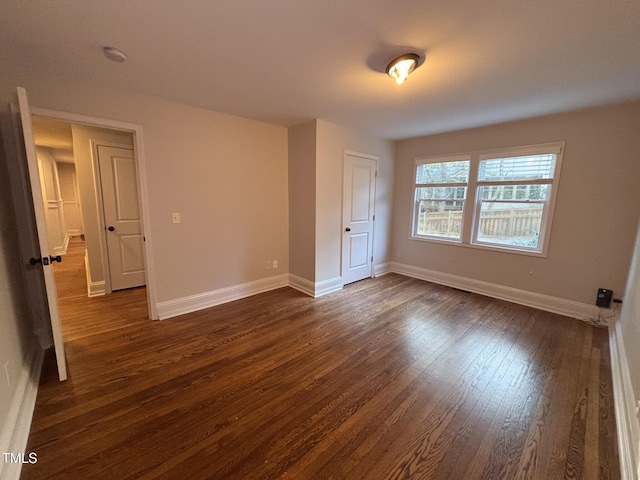 119 W Vernon Ave, Wake Forest, NC 27587 - unfurnished bedroom with dark wood-type flooring and baseboards