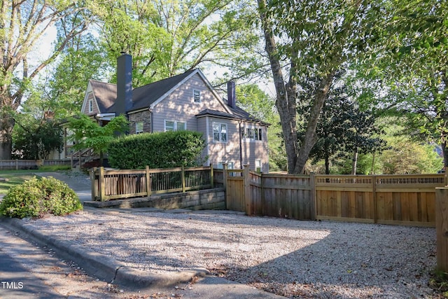 119 W Vernon Ave, Wake Forest, NC 27587 - view of property exterior with a chimney and metal roof