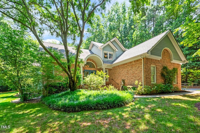 7401 Heartland Dr, Wake Forest, NC 27587 - traditional-style home featuring brick siding, a front yard, and roof with shingles