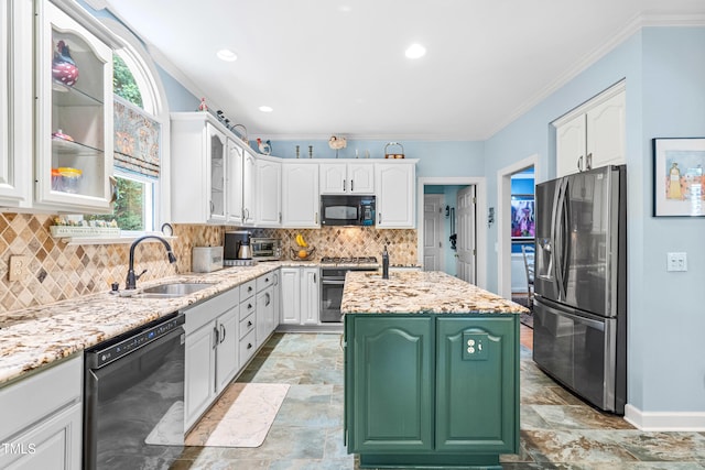 7401 Heartland Dr, Wake Forest, NC 27587 - kitchen featuring black appliances, a sink, white cabinets, a center island with sink, and ornamental molding