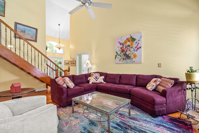 7401 Heartland Dr, Wake Forest, NC 27587 - living area with a towering ceiling, wood finished floors, stairs, a chandelier, and a ceiling fan