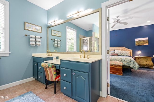 7401 Heartland Dr, Wake Forest, NC 27587 - ensuite bathroom featuring double vanity, ceiling fan, a stall shower, tile patterned flooring, and baseboards