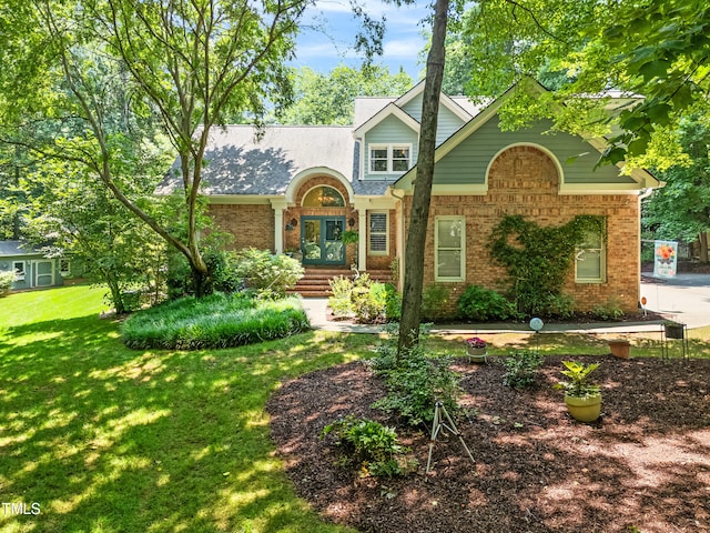 7401 Heartland Dr, Wake Forest, NC 27587 - traditional home with brick siding, a front lawn, and french doors