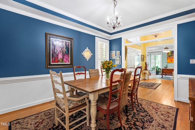 7401 Heartland Dr, Wake Forest, NC 27587 - dining space with a chandelier, ornamental molding, and light wood-style flooring