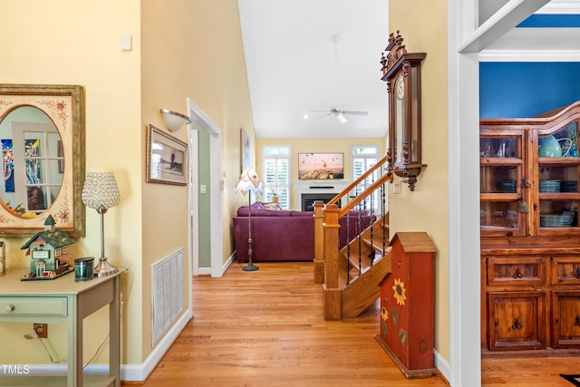 7401 Heartland Dr, Wake Forest, NC 27587 - corridor with light wood-style floors, stairs, baseboards, and lofted ceiling