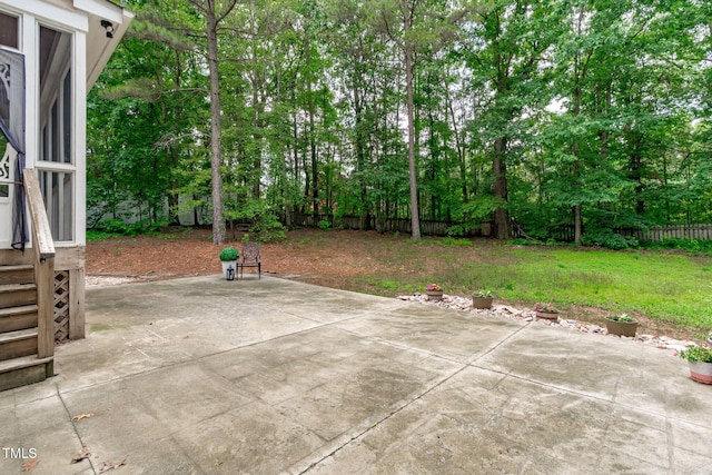 297 Curragh Cv, Fuquay Varina, NC 27526 - fenced backyard with a patio area and view of wooded area