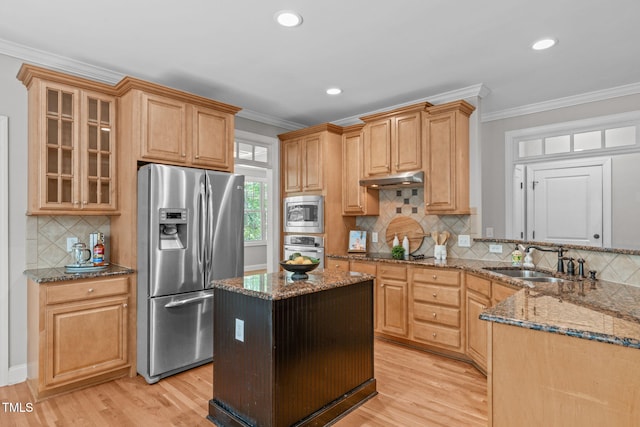 297 Curragh Cv, Fuquay Varina, NC 27526 - kitchen featuring stainless steel appliances, a sink, light wood-style flooring, dark stone countertops, and tasteful backsplash