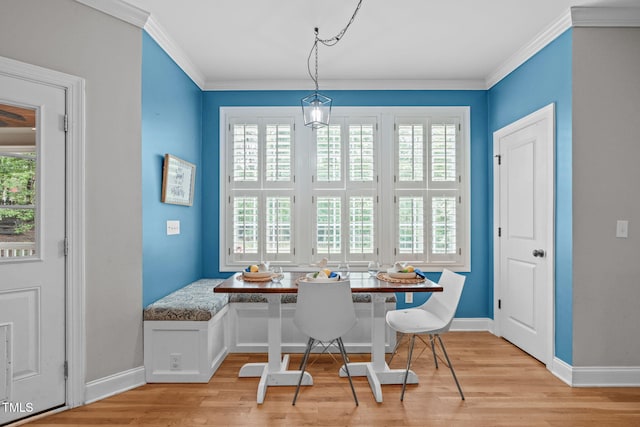 297 Curragh Cv, Fuquay Varina, NC 27526 - dining room featuring breakfast area, light wood-style floors, plenty of natural light, and ornamental molding