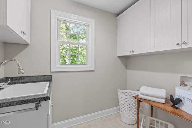 297 Curragh Cv, Fuquay Varina, NC 27526 - laundry area with baseboards, cabinet space, and washer hookup