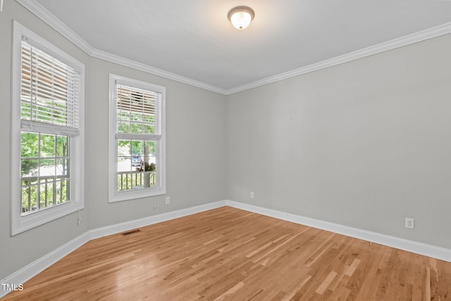 297 Curragh Cv, Fuquay Varina, NC 27526 - empty room featuring light wood-type flooring, healthy amount of natural light, baseboards, and ornamental molding