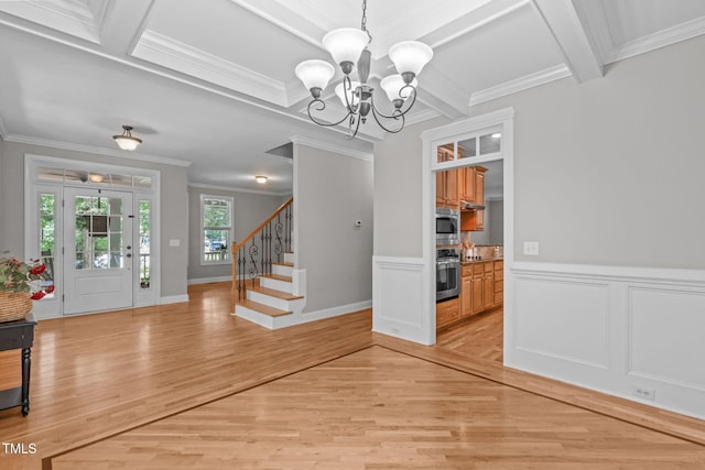 297 Curragh Cv, Fuquay Varina, NC 27526 - foyer entrance featuring a chandelier, crown molding, light wood-type flooring, stairs, and beamed ceiling