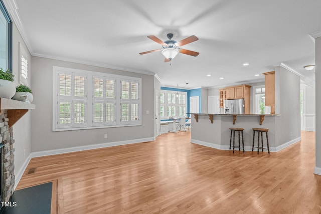 297 Curragh Cv, Fuquay Varina, NC 27526 - living area with ornamental molding, ceiling fan, a stone fireplace, baseboards, and light wood-style floors